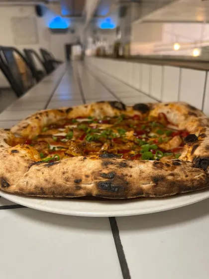 Another angle of our Adobo Chicken pizza, showing off the generous toppings and beautiful crust.