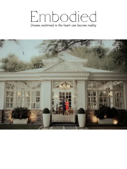 "Embodied." A wide shot of the couple standing in the doorway of a beautiful glasshouse. This image perfectly captures the dreamlike, fairytale quality of the location.