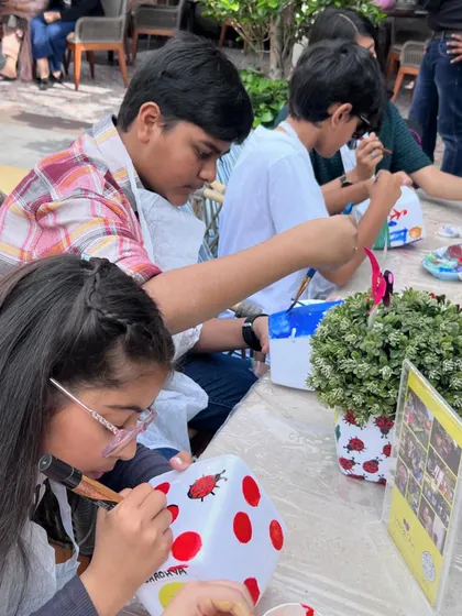 Concentration and creativity at our Enchanted Garden party. These young artists are carefully painting ladybugs on their planters, a fun and detailed activity that everyone enjoyed.