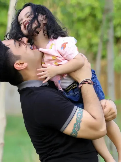 A candid and loving moment between a father and his daughter. These unposed shots are often the most precious memories from a family photoshoot.
