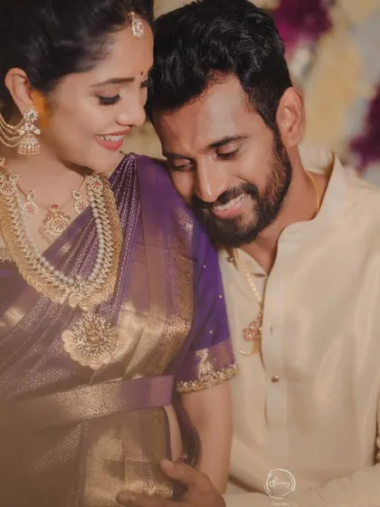 An intimate and loving moment between the happy couple at their baby shower.