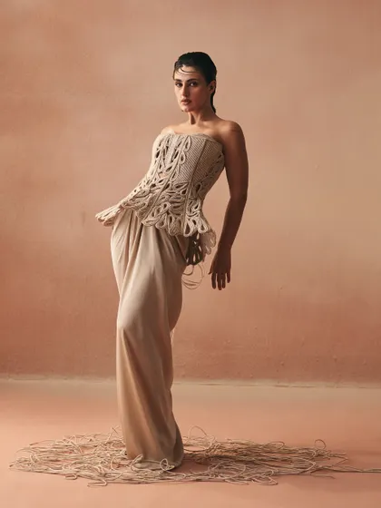 The Karov silhouette in motion, where the knotted cords of the sculpted corset are balanced by the fluid satin drape skirt, embodying the essence of my 'Cord Memory' collection.