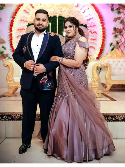A classic portrait of Anushka and Abhinav at their ring ceremony, posing against a festive backdrop.