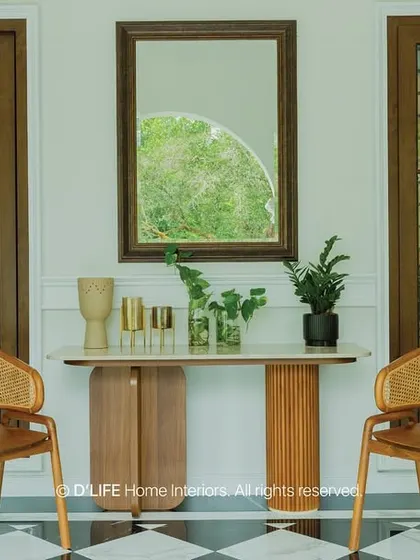 A closer look at the elegant entryway with its checkered floor, cane chairs, and simple console table, perfectly blending classic and contemporary design elements.