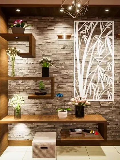 A close-up of a foyer or living room corner featuring a stone accent wall with intricate shelving and decorative vases. This highlights our attention to detail and material selection.