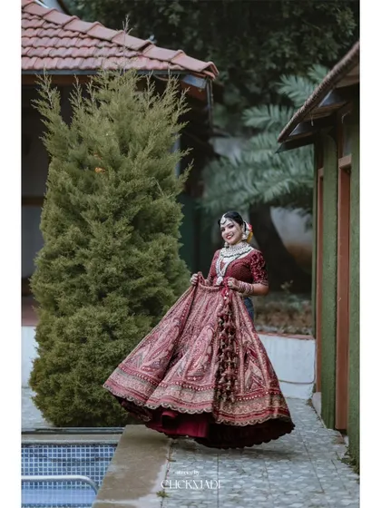 The bride joyfully twirls in her wedding lehenga, a perfect shot to capture the beauty and movement of her outfit.