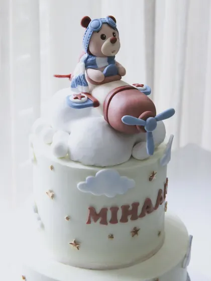 The cutest welcome cake for baby Mihaan. This two-tiered design features a teddy bear pilot flying high above the clouds.