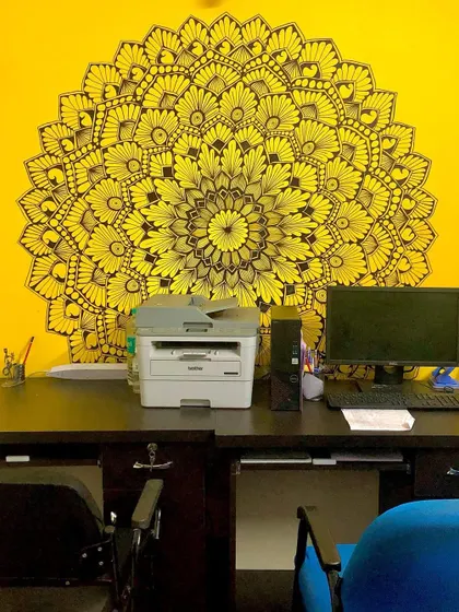 A vibrant yellow wall provides the perfect canvas for this black ink mandala at a commercial office. It’s designed to inspire creativity and brighten up the workspace.