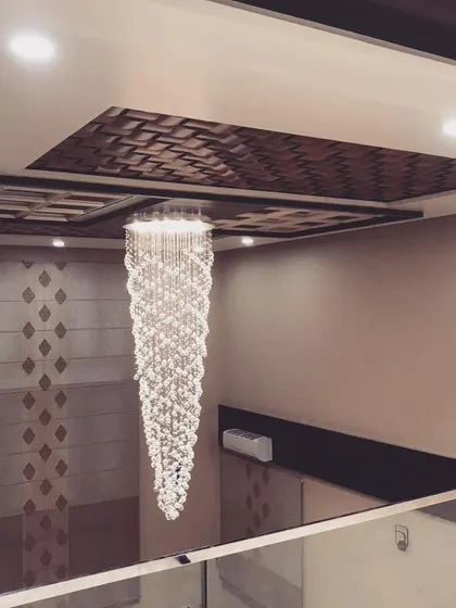 Another angle of the magnificent crystal chandelier, showcasing its intricate details and the way it reflects light.