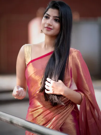 Modeling a gorgeous pink and gold tissue saree in the lively neighborhood of Malleshwaram. The shot captures the beauty of the saree in an everyday, authentic South Indian setting.