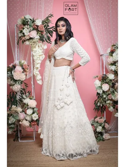 The final look, an ethereal white lehenga paired with a dramatic, smokey eye. This is a great example of a modern, high-fashion bridal or reception look.