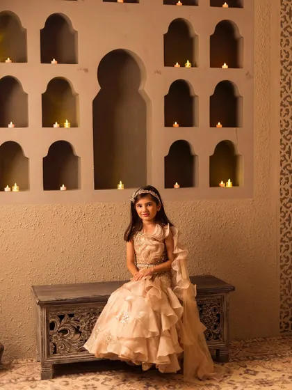 Seated gracefully, this view shows the comfortable yet stylish design of our ruffled indo western set.