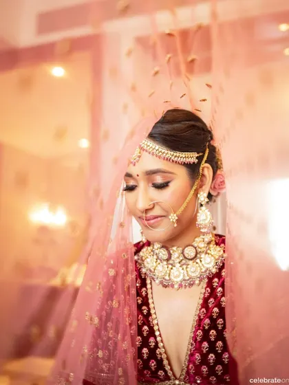 A soft, dreamy shot through the veil captures the essence of this bridal moment. The makeup features a shimmery eyeshadow and perfectly blended skin, creating a romantic and ethereal feel.