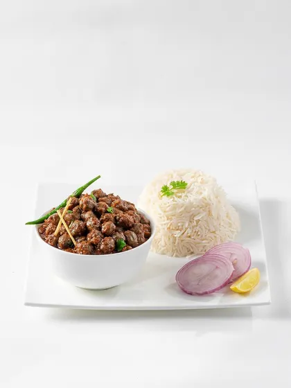 A simple and clean presentation of Chana Masala with steamed rice. This minimalist shot on a white background is designed for menus, focusing on the food itself without distracting props.