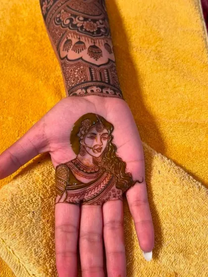 A detailed portrait of a bride, capturing her jewelry and expression in henna. This is a great way to add a personal touch to your bridal design.