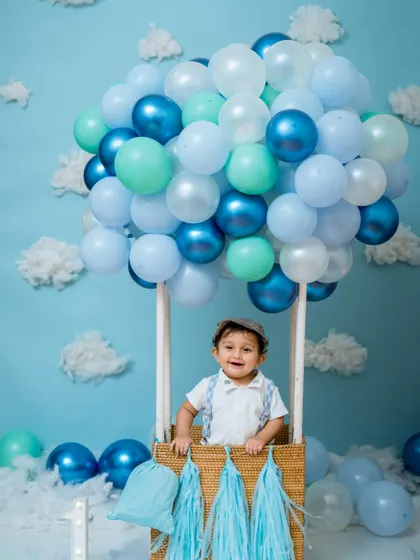 A big, happy smile from inside the basket. Our hot air balloon setup is designed to be safe and fun, allowing for adorable shots of your baby enjoying the ride.