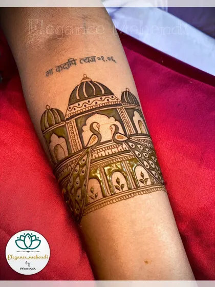 A bridal startup design with elegant peacocks and an architectural motif, with a personal tattoo just visible above.