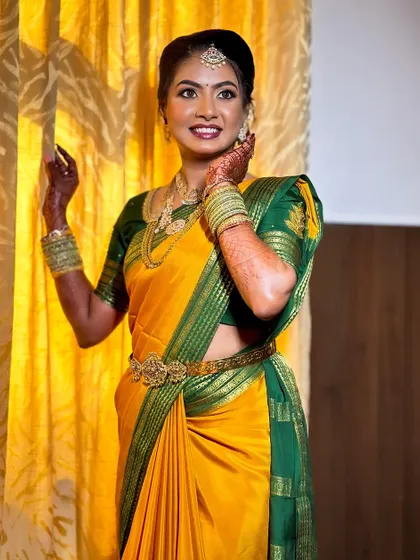 A joyful moment with one of my brides. Her traditional yellow and green saree is beautifully complemented by natural, glowing makeup.