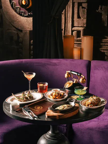 Another angle of the lounge seating at Ocho Bandra, highlighting the unique decor like the vintage telephone and elegant lighting.