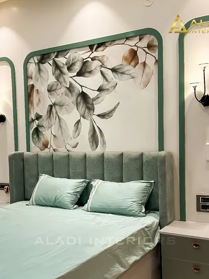 A close-up of the headboard, detailing the delicate floral artwork and the elegant wall sconces that provide soft, ambient lighting.