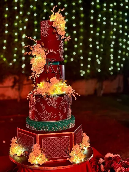 Another angle of the magnificent Delhi wedding cake, showing the hexagonal base and the warm glow of the sugar flowers.