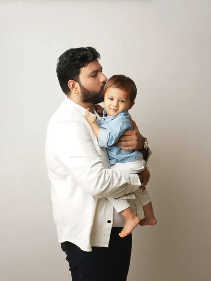 A father's gentle kiss for his son. These are the quiet, loving moments that build the foundation of a strong family bond.