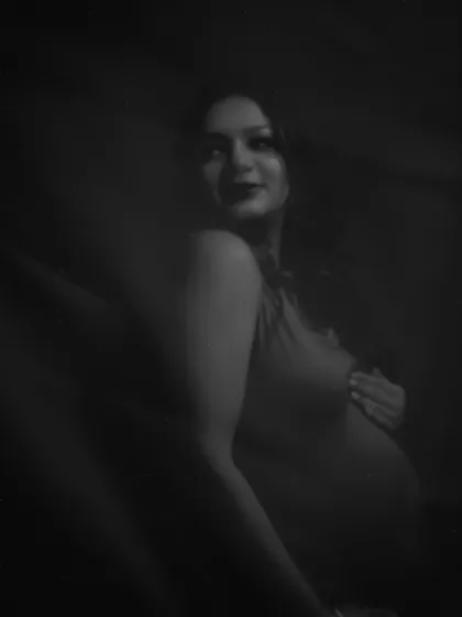 A love letter to resilience. This dark, moody black and white portrait is filled with emotion and strength, capturing the profound transformation of motherhood.