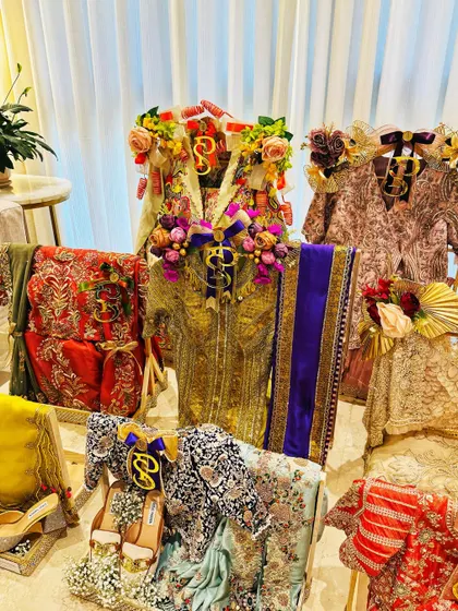 The vibrant colors of a wedding trousseau, beautifully arranged. This setup showcases a mix of traditional and contemporary outfits, each presented with its own unique flair.