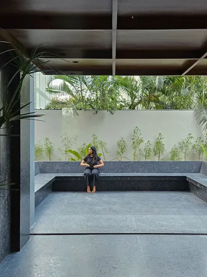 An outdoor breakout and seating area designed with black granite. This space serves as a tranquil extension of the office interior, providing a connection to nature for employees and visitors, embodying our approach to biophilic architecture.