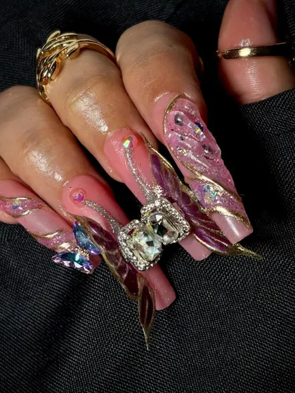 A close-up on the stunning 3D butterfly charm with a large crystal, a true statement piece of nail art.