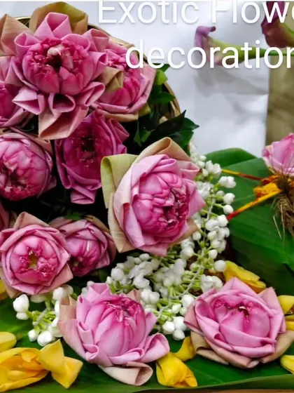 A traditional Indian floral arrangement featuring beautifully folded pink lotus buds. This type of decoration is ideal for religious ceremonies, festivals like Ganesh Chaturthi, or auspicious occasions.