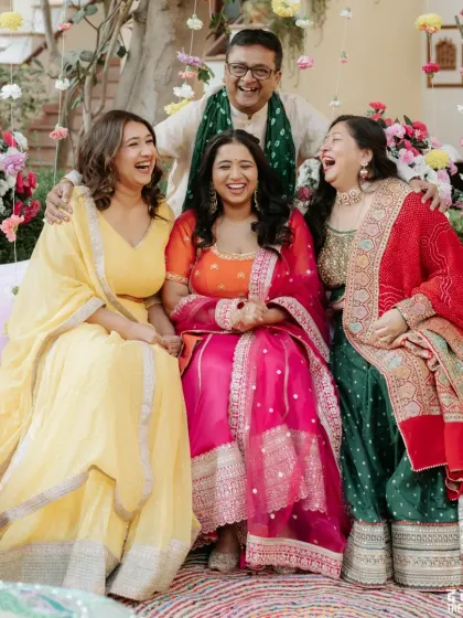 A happy family portrait filled with laughter during the Mehendi ceremony.