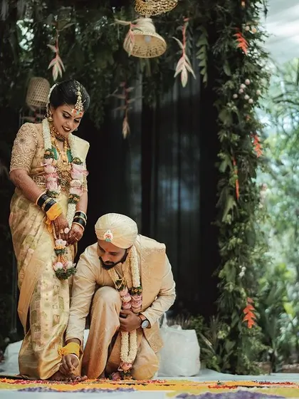 The Saptapadi, or seven steps, is a beautiful ritual symbolizing the journey of life together. I captured this moment against a lush, green backdrop, highlighting the sacred steps.