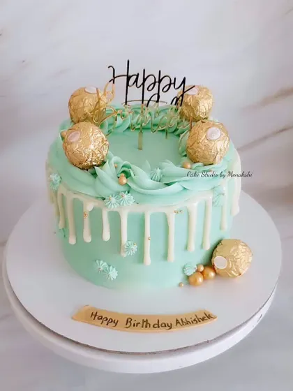 A lovely teal and gold cake adorned with Ferrero Rochers. This zero-fondant design features a white chocolate drip and is perfect for someone who loves a bit of indulgence.