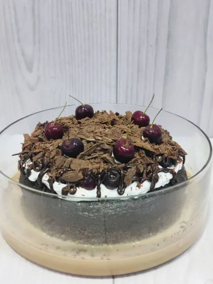 My take on a classic, this is the Black Forest Tres Leches. It features a rich chocolate sponge soaked in my signature milk blend, layered with cream, and topped with chocolate shavings and fresh cherries.