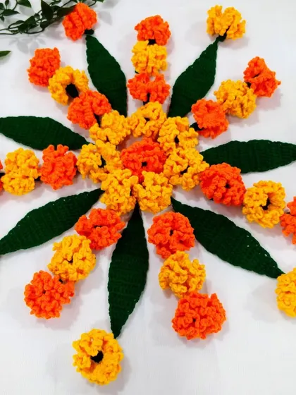 A beautiful circular rangoli arrangement made with my crochet marigold flowers and mango leaves. It's a wonderful, eco-friendly way to decorate your floor during festivals.