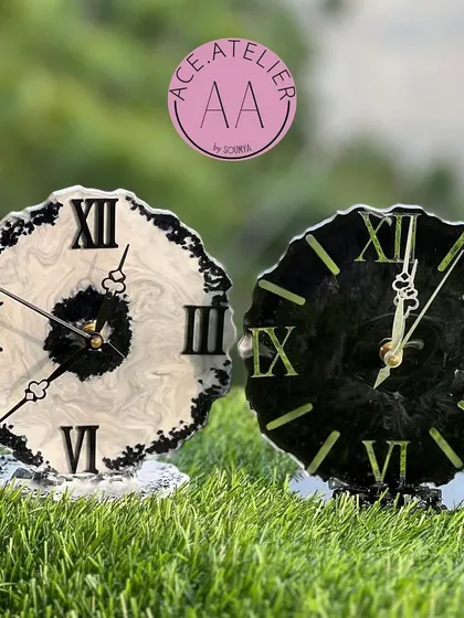 A matching set of black and white resin table clocks with a geode edge, perfect for a minimalist and modern decor style.