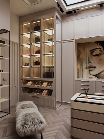 A large piece of art adds a personal and dramatic touch to the wardrobe. This view also shows the dedicated, illuminated shelving for handbags.