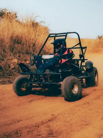 Dirt, speed, and pure adrenaline. A dirt kart kicks up dust as it speeds around a corner on our track.