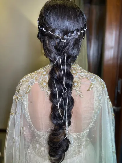 A classic braid gets a glamorous update with delicate diamond chains woven through it. This is a perfect look for a Sangeet or Reception.