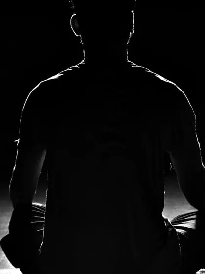 The work isn't over when the training ends. A fighter sits in meditation, calming his mind and reflecting on the session.