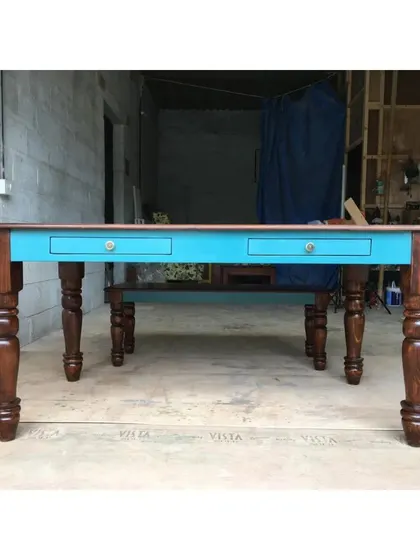 Another look at the vibrant blue apron on this sturdy, handcrafted table.