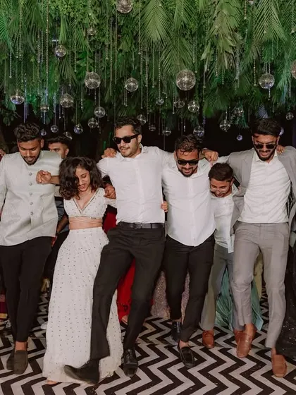 The groom and his friends share a fun moment on the dance floor, highlighting the celebratory vibe of the event.