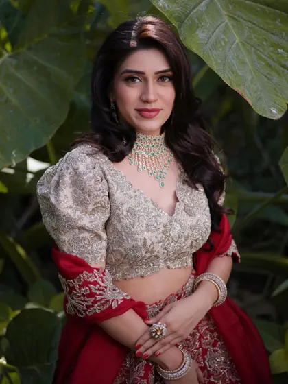 Mahima looking directly at the camera, her makeup perfectly applied. The look is a beautiful example of soft glam, suitable for a day or evening engagement event.