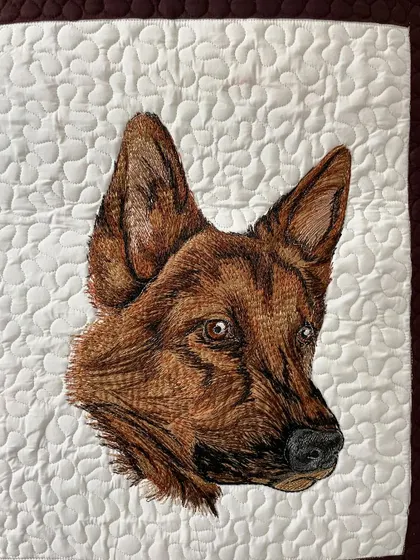 The German Shepherd portrait, showcasing the detailed thread work used to create its distinct features.