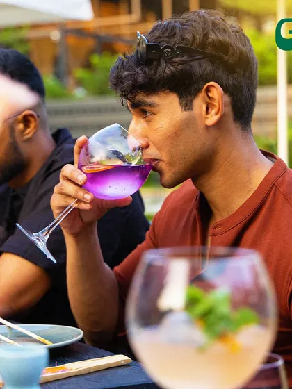 Just a boy, his cocktail, and all the good vibes. A guest enjoying one of our colorful drinks.