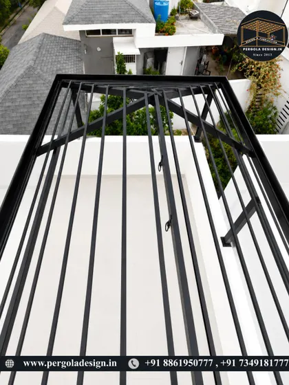 An overhead shot of the black pergola frame, highlighting the radial design of the rafters.