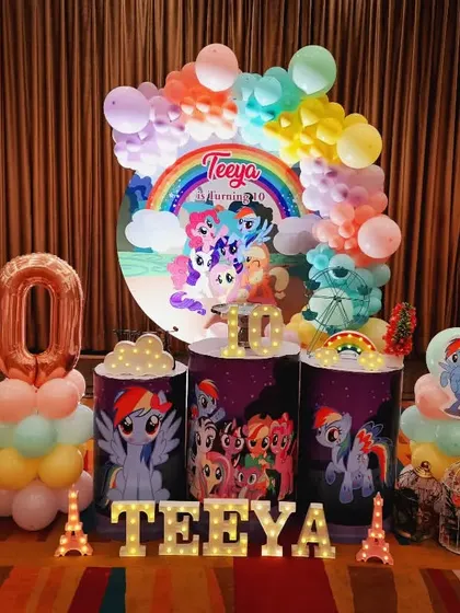A vibrant My Little Pony party for Teeya's 10th birthday. The decor is filled with rainbows and all her favorite pony characters, complete with large foil number balloons.