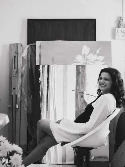 Brush in hand, existential dread in heart. A candid black and white portrait from my studio that captures the playful and introspective reality of being an artist.