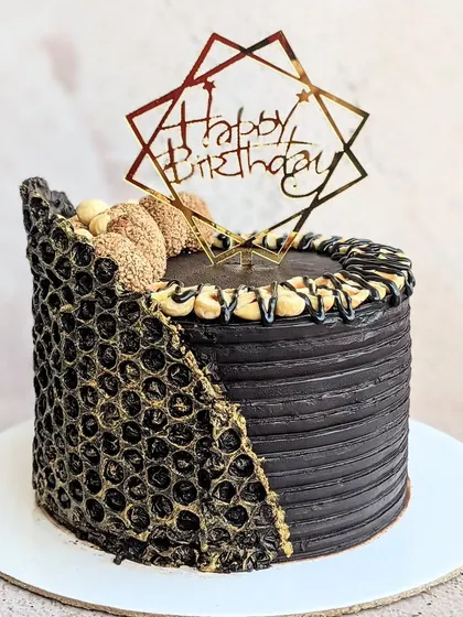 A full view of the 16th birthday chocolate cake, showing the unique bubble wrap chocolate collar and the rich, dark ganache frosting.